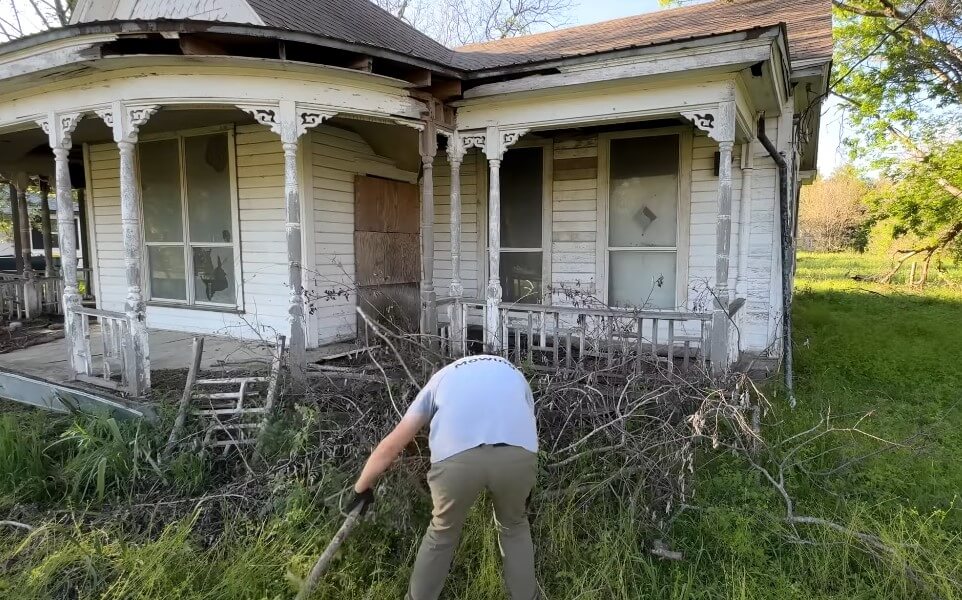 Guy removing vegetation from backyard