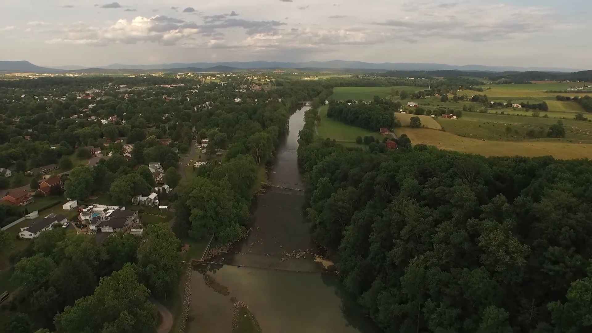 Aerial view of Bridgewater, Virginia, with a river running through green fields and residential areas