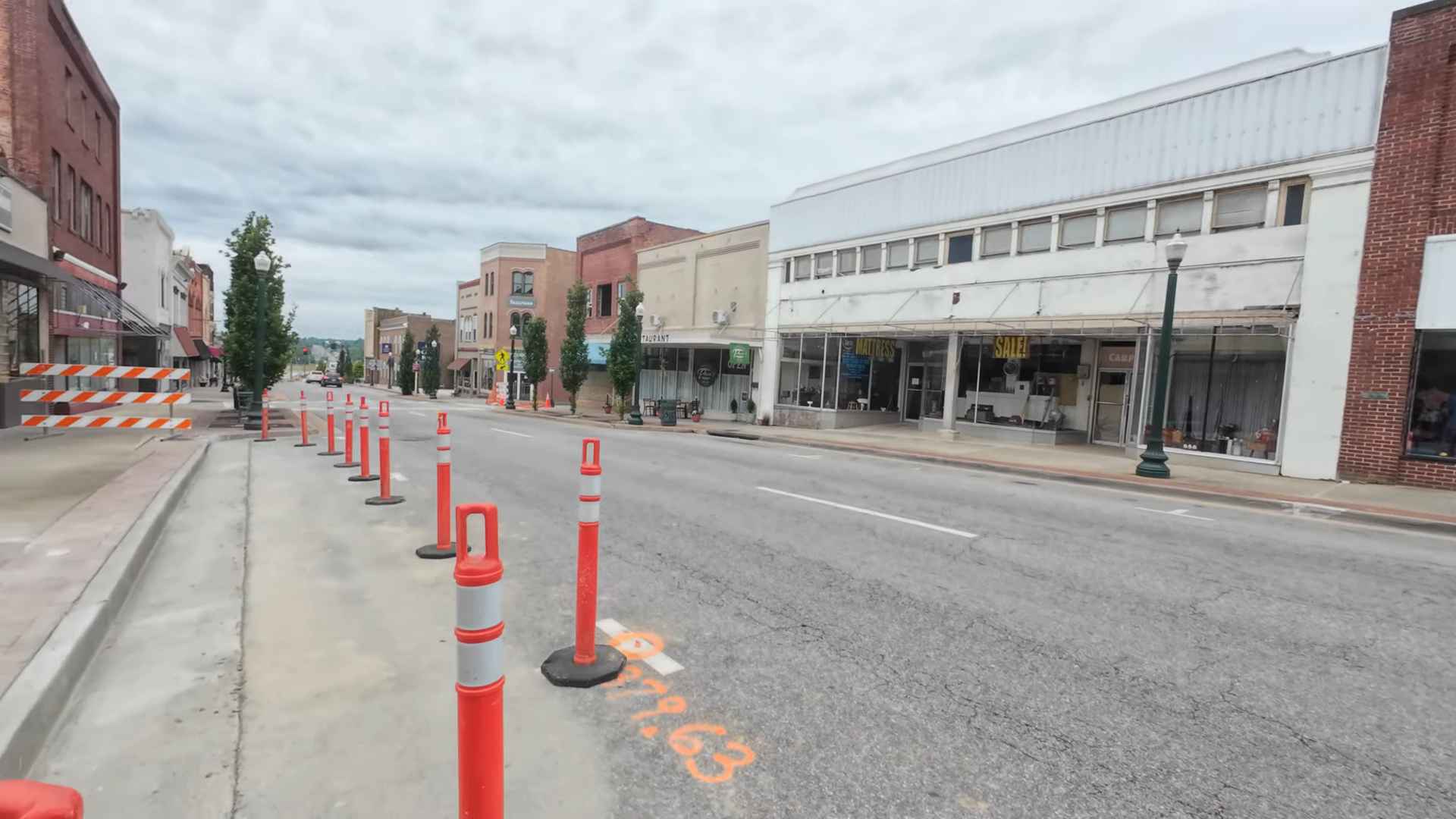 Street view of South Boston, Virginia, with orange construction barriers and historic buildings lining the road