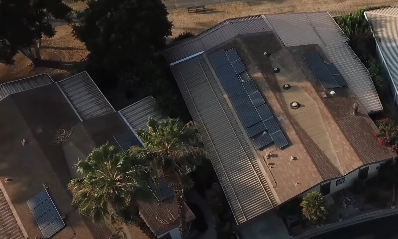 Drone view of a house with solar panel roof