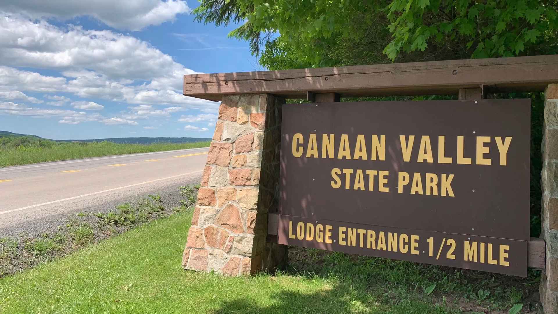 Sign for Canaan Valley State Park beside a rural road and grassy landscape