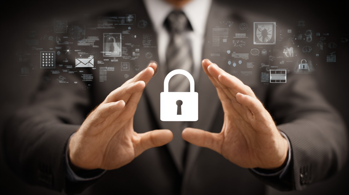 Businessperson holding a digital padlock icon between their hands